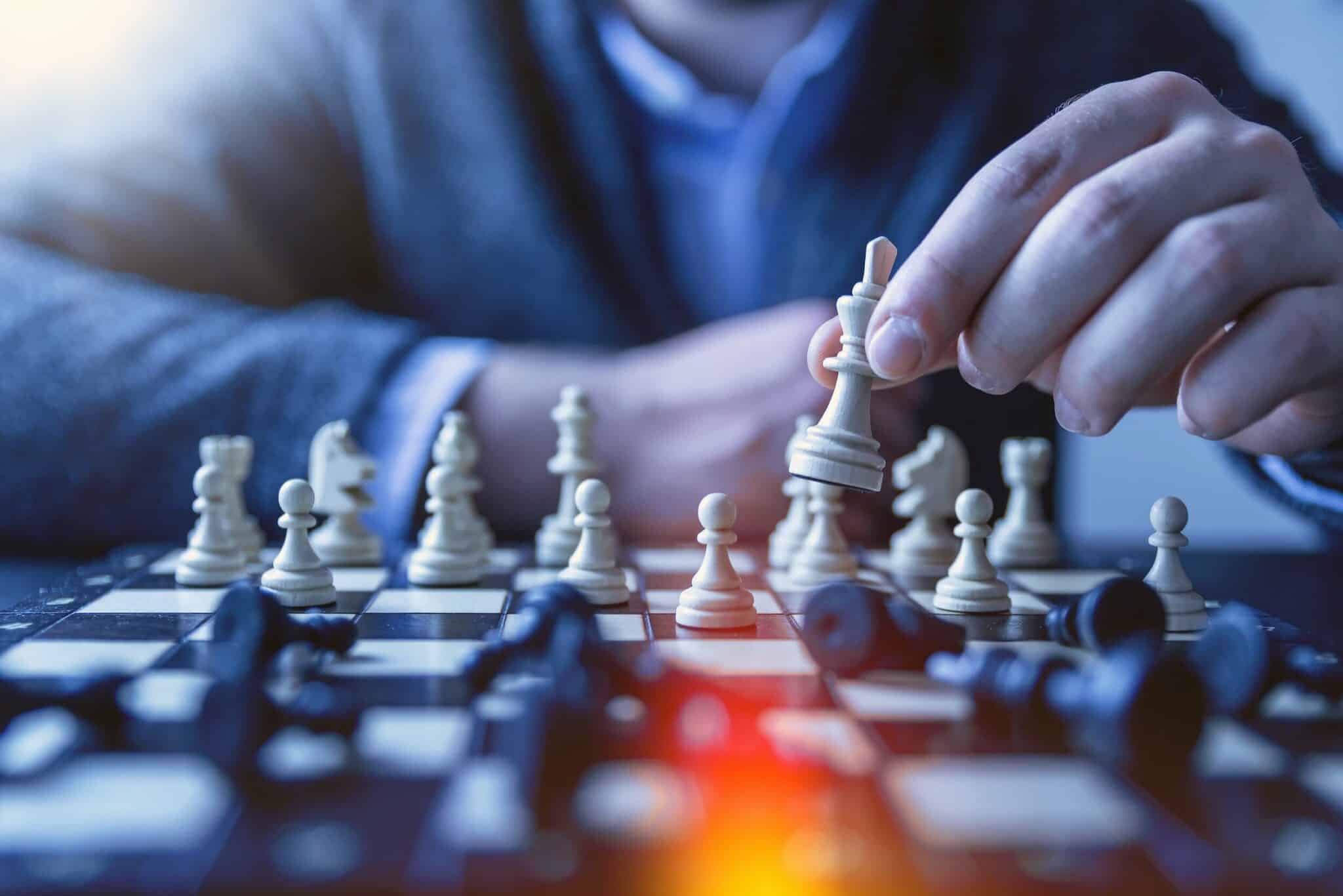 Man making move on chess board